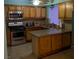 Traditional kitchen with stainless steel appliances, wooden cabinets, and tiled flooring at 5268 Gains Mill St, Las Vegas, NV 89122