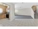 Open-concept living area with a partial view of the kitchen and access to the staircase at 5331 Heatherbrook Cir, Las Vegas, NV 89120