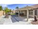 Backyard patio with a grill and built in countertop, with a patch of grass and desert landscaping at 5437 Escallonia St, Las Vegas, NV 89149