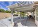 Covered backyard patio with an outdoor kitchen and ample space for seating and entertaining at 5437 Escallonia St, Las Vegas, NV 89149