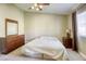 Bedroom with neutral walls, a ceiling fan and a view of the window and curtains at 5437 Escallonia St, Las Vegas, NV 89149