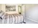 Bedroom featuring neutral walls, carpet, and artwork, as well as a view into another bedroom at 5437 Escallonia St, Las Vegas, NV 89149