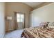 Cozy bedroom with neutral walls, carpet, and vaulted ceilings, featuring a large window and accent lamp at 5437 Escallonia St, Las Vegas, NV 89149