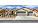Charming stucco home with a three car garage, desert landscaping, and a red tile roof at 5437 Escallonia St, Las Vegas, NV 89149