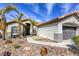Beautiful desert landscaping, stucco exterior, and walkway to the front door of this single-Gathering home at 5437 Escallonia St, Las Vegas, NV 89149