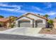 Charming home featuring a three-car garage, desert landscaping, and a classic tile roof at 5437 Escallonia St, Las Vegas, NV 89149