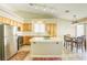 Bright kitchen features stainless steel appliances, tile countertops and backsplash, and breakfast bar seating at 5437 Escallonia St, Las Vegas, NV 89149