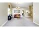 Spacious living room with carpet, tiled floors, and arched doorway in a neutral color palette at 5437 Escallonia St, Las Vegas, NV 89149