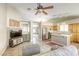 Cozy living room boasts tiled floors, ceiling fan, and an open floor plan with sight lines into the kitchen at 5437 Escallonia St, Las Vegas, NV 89149