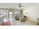 Living room with tiled floors, sofa, ceiling fan, and a view of the back yard at 5437 Escallonia St, Las Vegas, NV 89149