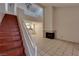 Bright living room featuring tile floors, a fireplace, and an open staircase to the upper level at 5526 Orchard Ln # 0, Las Vegas, NV 89110