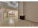 Inviting living room with tile flooring, a fireplace, and loft access overlooking the kitchen area at 5526 Orchard Ln # 0, Las Vegas, NV 89110