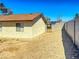 Backyard featuring a mix of desert landscaping and block wall fencing for added privacy at 6397 Kell Ln, Las Vegas, NV 89156