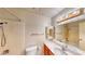 Bright bathroom with tiled shower, functional toilet, and ample counter space with a large mirror at 6397 Kell Ln, Las Vegas, NV 89156