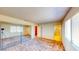 Bright bedroom features carpet, a window with blinds, and a closet with mirrored doors, creating a comfortable at 6397 Kell Ln, Las Vegas, NV 89156