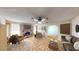 Bright living room with a brick fireplace, ceiling fan, and neutral decor at 6397 Kell Ln, Las Vegas, NV 89156