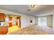 Open-concept living space with kitchen access and sliding glass doors to the exterior at 6397 Kell Ln, Las Vegas, NV 89156