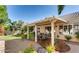 Inviting backyard boasting a covered patio and lush landscaping at 64 Chateau Whistler Ct, Las Vegas, NV 89148
