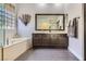 Bathroom with dual vanities, soaker tub, and natural light at 64 Chateau Whistler Ct, Las Vegas, NV 89148