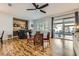Dining area with modern decor, wood floors, bar and sliding glass door to the patio at 64 Chateau Whistler Ct, Las Vegas, NV 89148