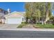 Charming single-story home featuring a well-maintained front yard and a two-car garage at 64 Chateau Whistler Ct, Las Vegas, NV 89148