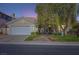 Charming single-story home featuring a well-maintained front yard and a two-car garage at 64 Chateau Whistler Ct, Las Vegas, NV 89148