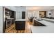 A kitchen with wood floors, dark cabinets, a center island, and stainless appliances at 64 Chateau Whistler Ct, Las Vegas, NV 89148
