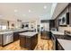 Kitchen with stainless appliances, granite countertops, wood floors, and dark wood cabinets at 64 Chateau Whistler Ct, Las Vegas, NV 89148