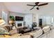 Cozy living room with fireplace, comfortable seating, and wood floors at 64 Chateau Whistler Ct, Las Vegas, NV 89148