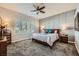 A main bedroom with carpet, a ceiling fan, and many windows at 64 Chateau Whistler Ct, Las Vegas, NV 89148