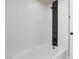 Bright white soaking tub with black accents and tiled wall feature at 6401 Goldmine Dr, Las Vegas, NV 89156