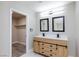 Updated bathroom featuring a modern vanity with double sinks and a spacious walk-in closet at 6401 Goldmine Dr, Las Vegas, NV 89156