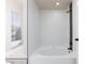 Bathroom featuring a soaking tub, white tile walls, and a tiled feature accent at 6401 Goldmine Dr, Las Vegas, NV 89156