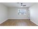 Bright bedroom with wood floors and ceiling fan, enhanced by natural light from the window at 6401 Goldmine Dr, Las Vegas, NV 89156