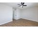 Bright bedroom with wood floors and ceiling fan, enhanced by natural light from the window at 6401 Goldmine Dr, Las Vegas, NV 89156