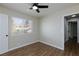 Bright bedroom with wood floors and ceiling fan, enhanced by natural light from the window at 6401 Goldmine Dr, Las Vegas, NV 89156