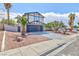 Inviting two-story home with a well-manicured front yard, desert landscaping, and a spacious driveway at 6401 Goldmine Dr, Las Vegas, NV 89156
