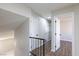 Upstairs hallway featuring new flooring and multiple bedroom doors at 6401 Goldmine Dr, Las Vegas, NV 89156