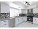 Updated kitchen featuring white cabinets, granite counters, and stainless steel appliances at 6401 Goldmine Dr, Las Vegas, NV 89156