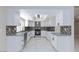 Bright kitchen with white cabinets, stainless steel appliances, and stylish backsplash at 6401 Goldmine Dr, Las Vegas, NV 89156