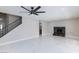 Inviting living room features a cozy fireplace, tile floors, and a modern ceiling fan at 6401 Goldmine Dr, Las Vegas, NV 89156