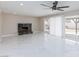 Bright and open living room featuring tile flooring, a fireplace, and large sliding doors at 6401 Goldmine Dr, Las Vegas, NV 89156