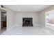 Modern living room featuring a cozy fireplace, tile floors, and bright lighting at 6401 Goldmine Dr, Las Vegas, NV 89156