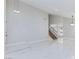 Inviting living room features high ceilings, bright white tile, and a staircase at 6401 Goldmine Dr, Las Vegas, NV 89156