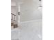 Spacious living room featuring bright white walls, tile floors, and staircase at 6401 Goldmine Dr, Las Vegas, NV 89156