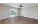 Spacious main bedroom featuring wood floors, ceiling fan, and balcony access at 6401 Goldmine Dr, Las Vegas, NV 89156