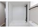 Modern shower with a black showerhead and fixtures, complemented by contrasting white tiles at 6401 Goldmine Dr, Las Vegas, NV 89156