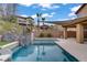 Backyard oasis with a pool, spa, lush landscaping, and a sunshade, creating the perfect relaxation spot at 651 Penshaw Bridge Ave, Las Vegas, NV 89178