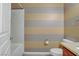Cozy bathroom with striped walls, granite countertop and under-sink cabinet at 651 Penshaw Bridge Ave, Las Vegas, NV 89178
