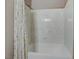 Bathroom featuring a white bathtub with decorative shower curtain at 651 Penshaw Bridge Ave, Las Vegas, NV 89178